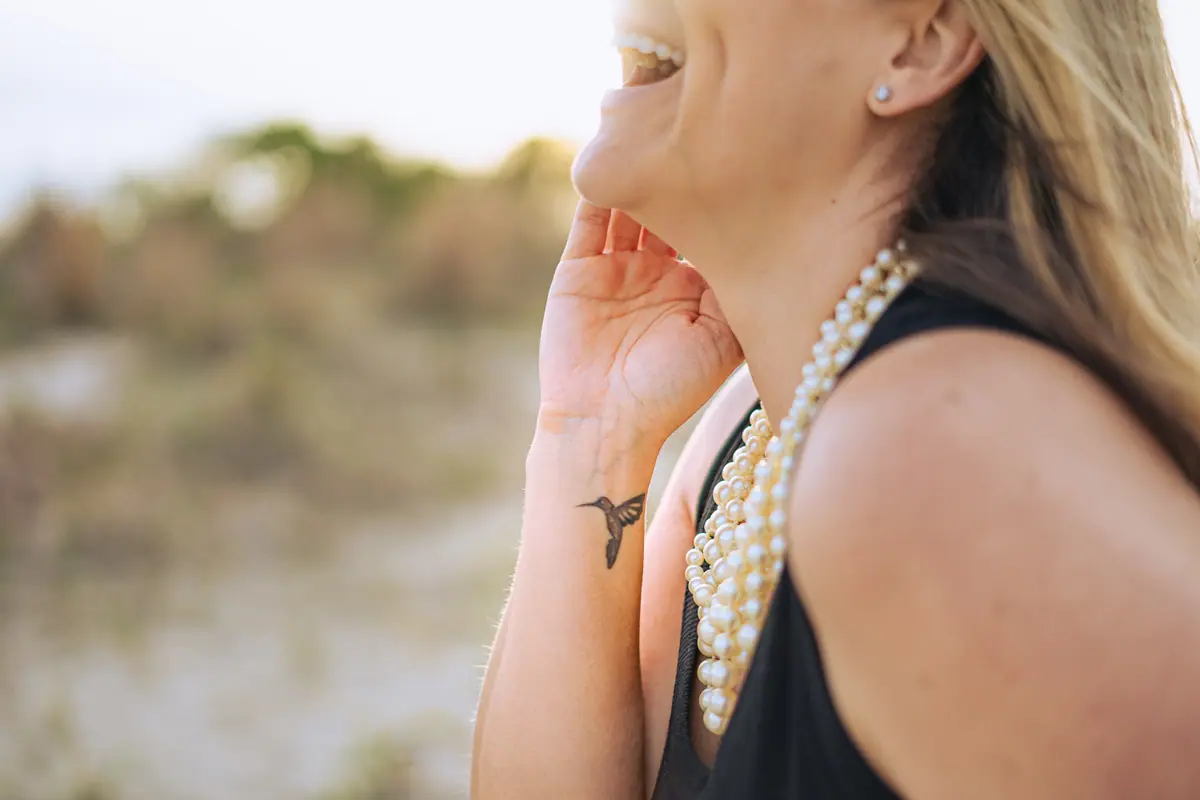 A woman laughing outdoors in the evening light